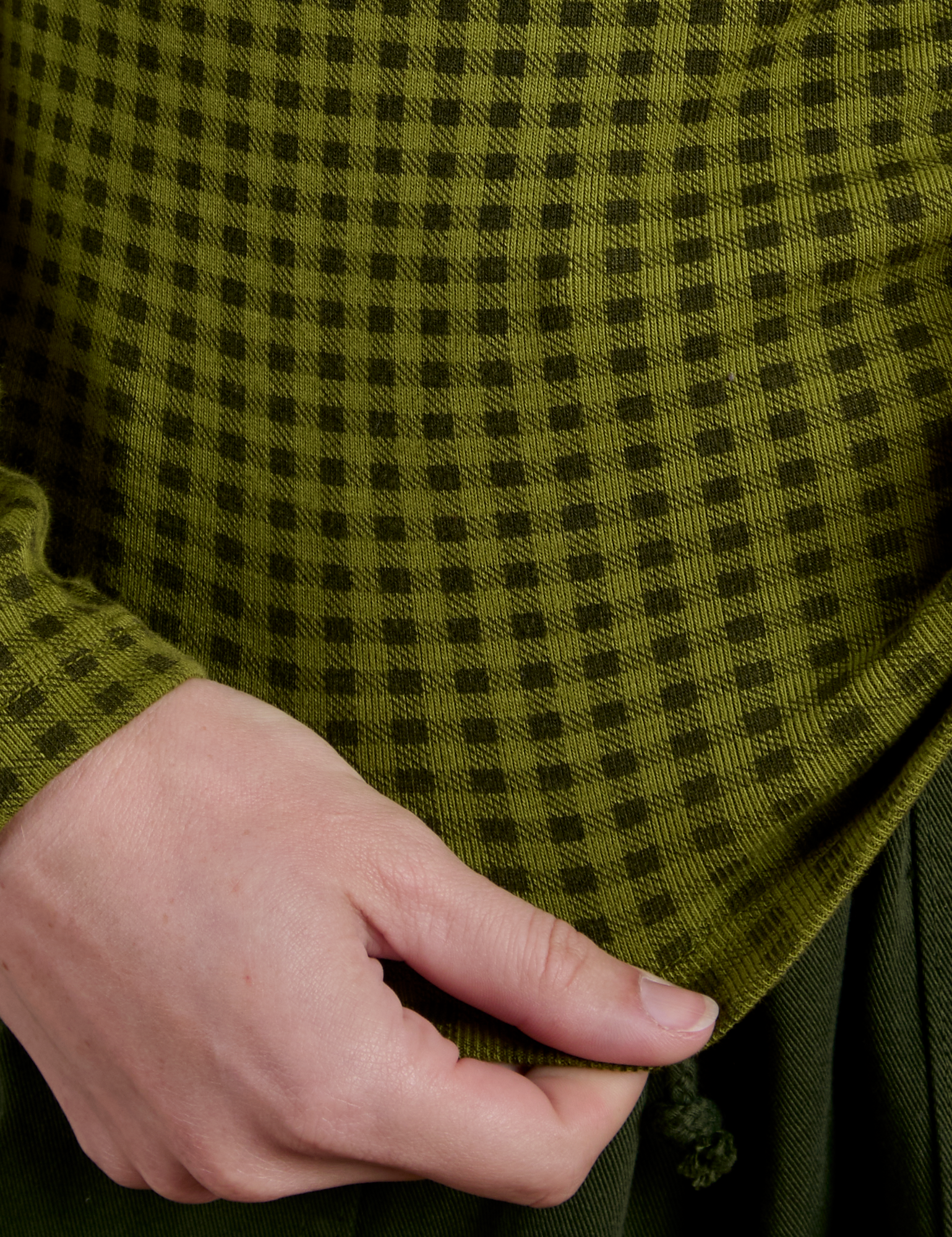 Bottom close up of Gingham Long Sleeve Baby Tee in Summer Olive on Alex
