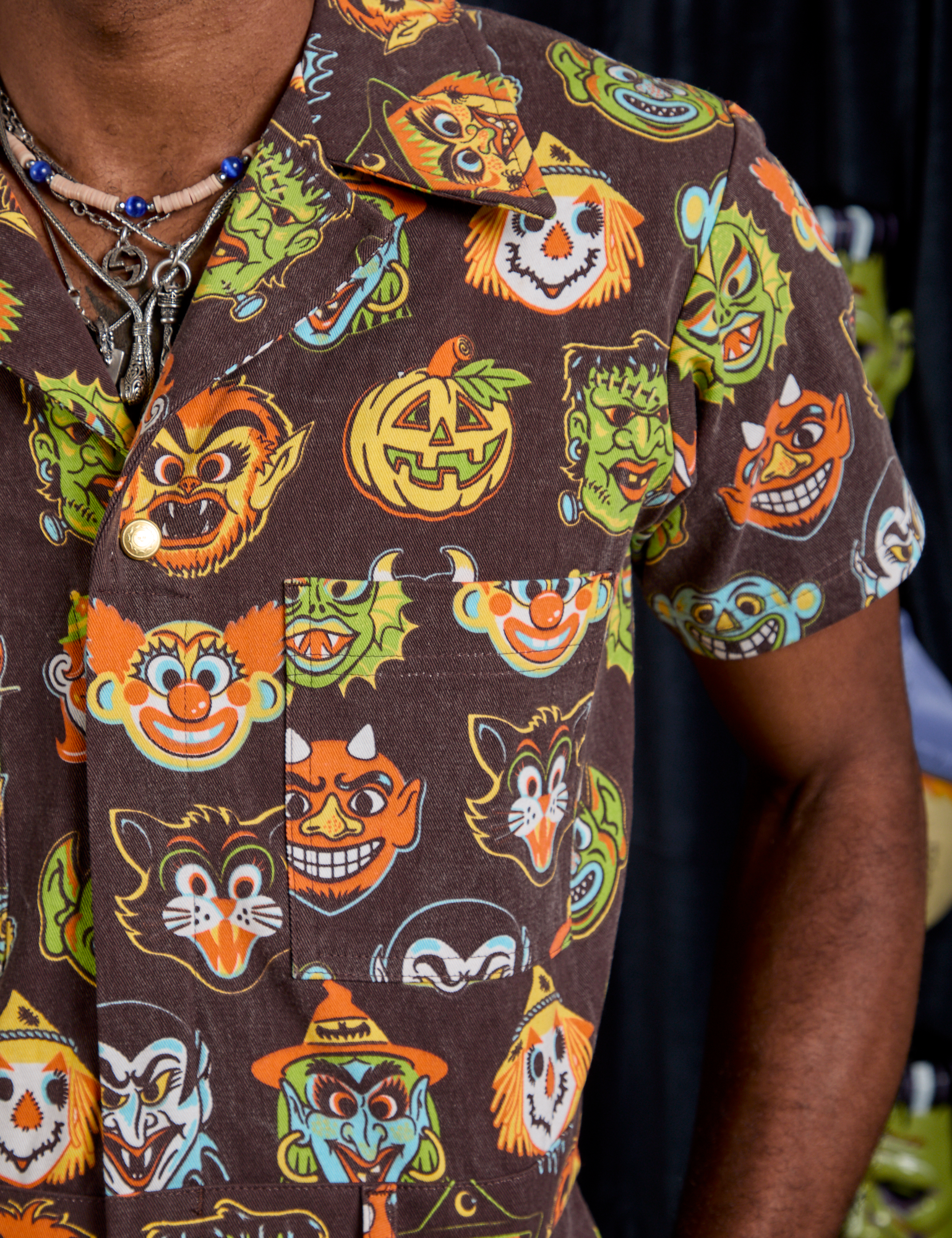 Short Sleeve Jumpsuit in Halloween Masks front close up on Jerrod