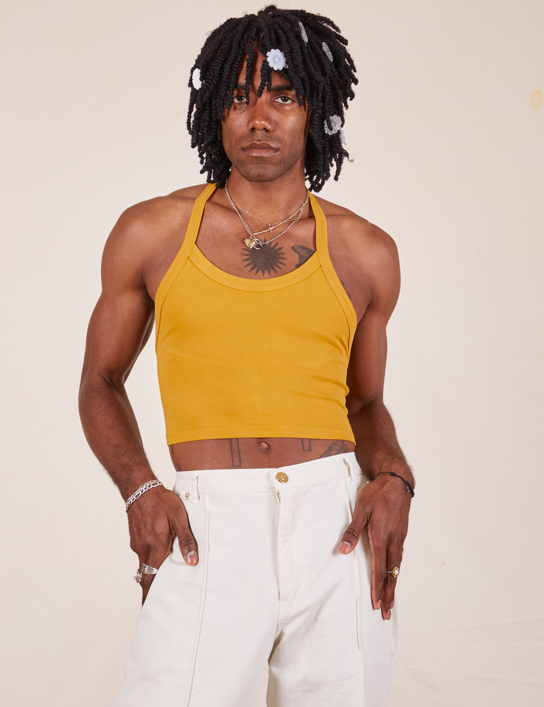 Jerrod is wearing Halter Top in Mustard Yellow and vintage off-white Western Pants