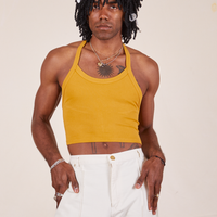 Jerrod is wearing Halter Top in Mustard Yellow and vintage off-white Western Pants