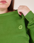 Heavyweight Crew in Lawn Green front close up on Marielena. Embroidered Sun Baby logo.