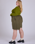 Side view of Pleated Trouser Shorts in Surplus Green and summer olive Long Sleeve Baby Tee