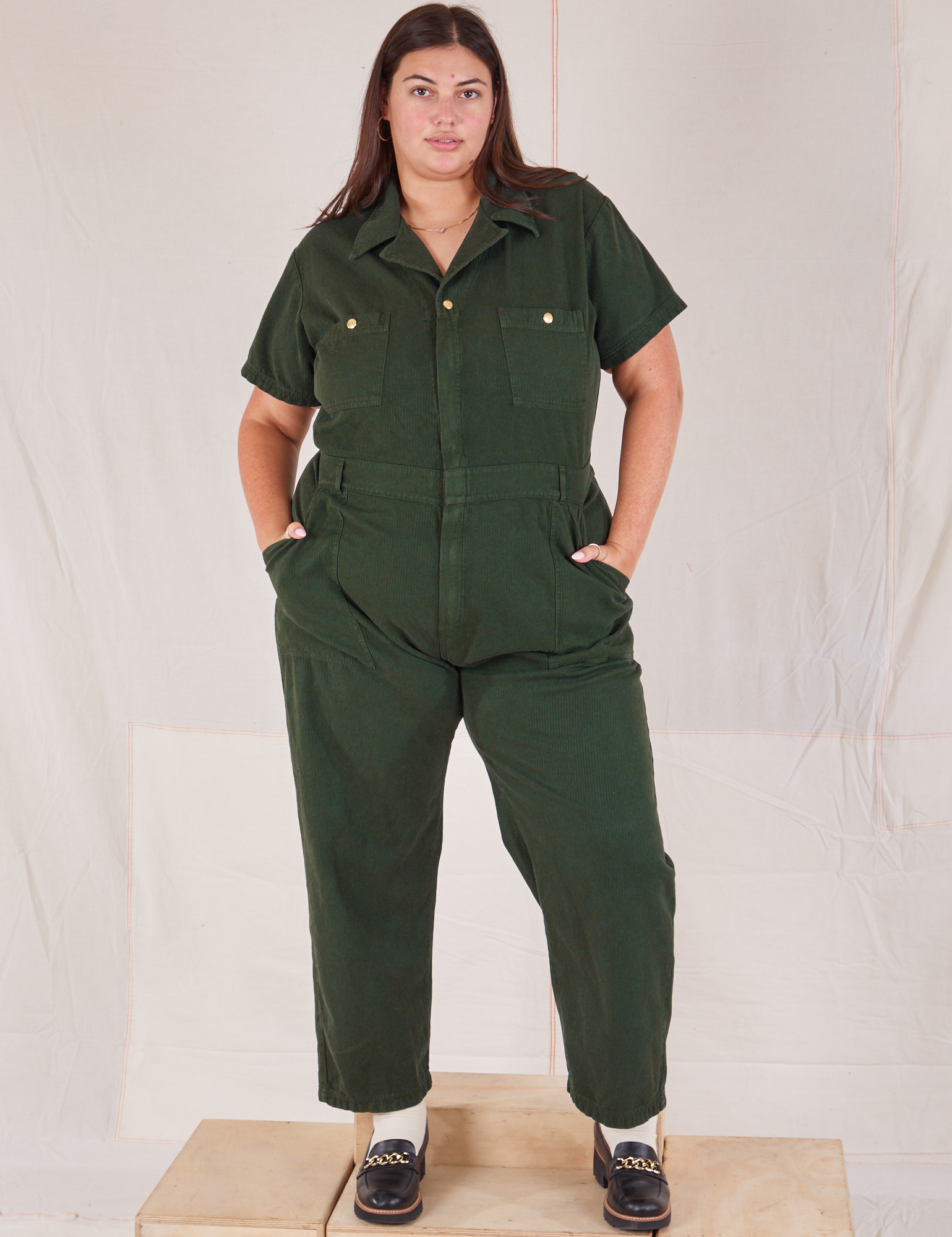 Katie is 6’2” and wearing 2XL Heritage Short Sleeve Jumpsuit in Swamp Green