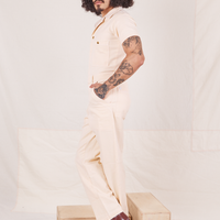 Side view of Heritage Short Sleeve Jumpsuit in Natural worn by Jesse