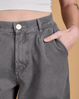Close up of Alex's hand in the front pocket of Heritage Wide Leg Trousers in Washed Grey