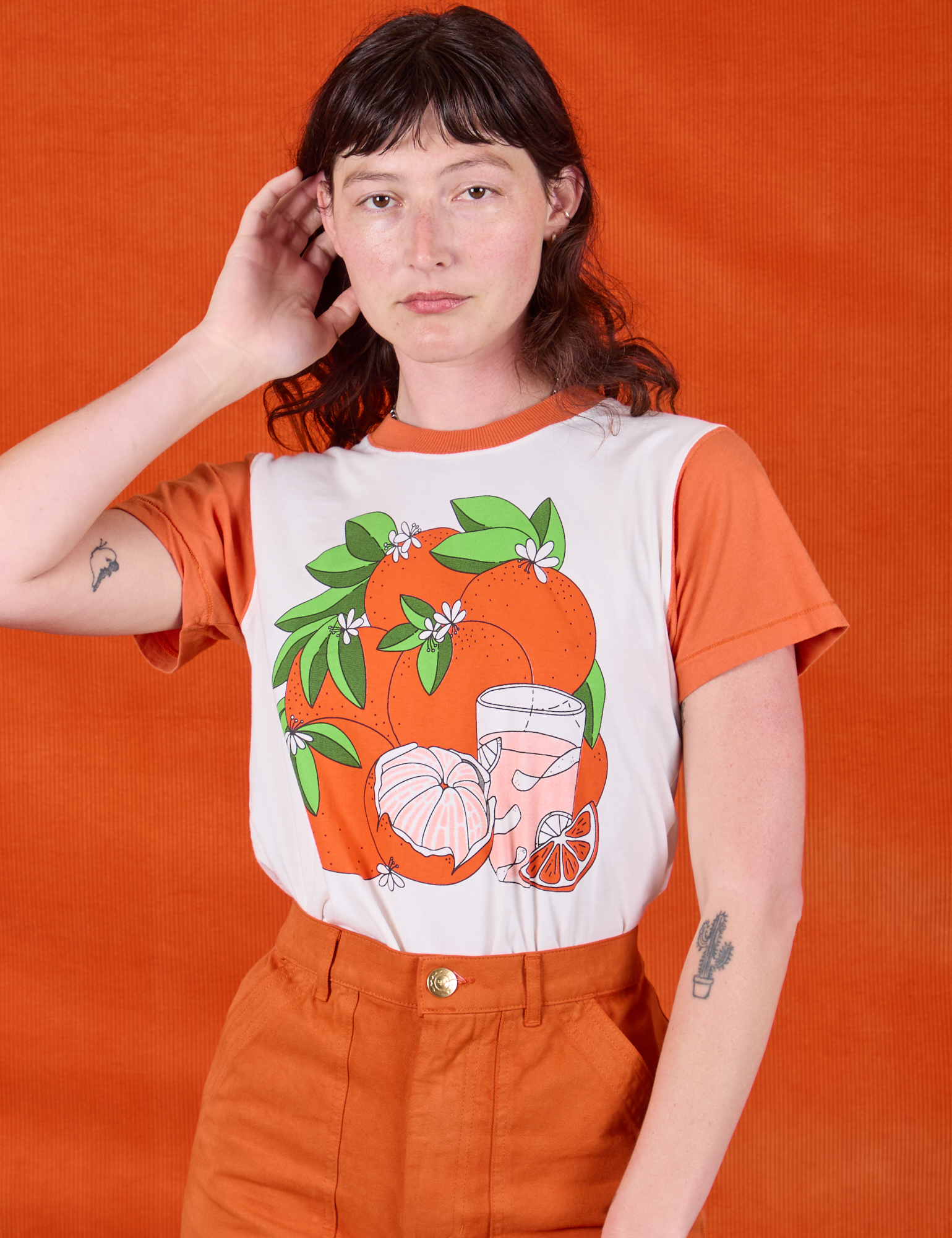 Alex is wearing Anniversary Tee in Orange Blossom tucked into Work Shorts