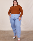 Marielena is wearing Honeycomb Thermal in Burnt Terracotta tucked into light wash Denim Trousers