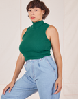 Angled view of Sleeveless Essential Turtleneck in Hunter Green worn by Tiara