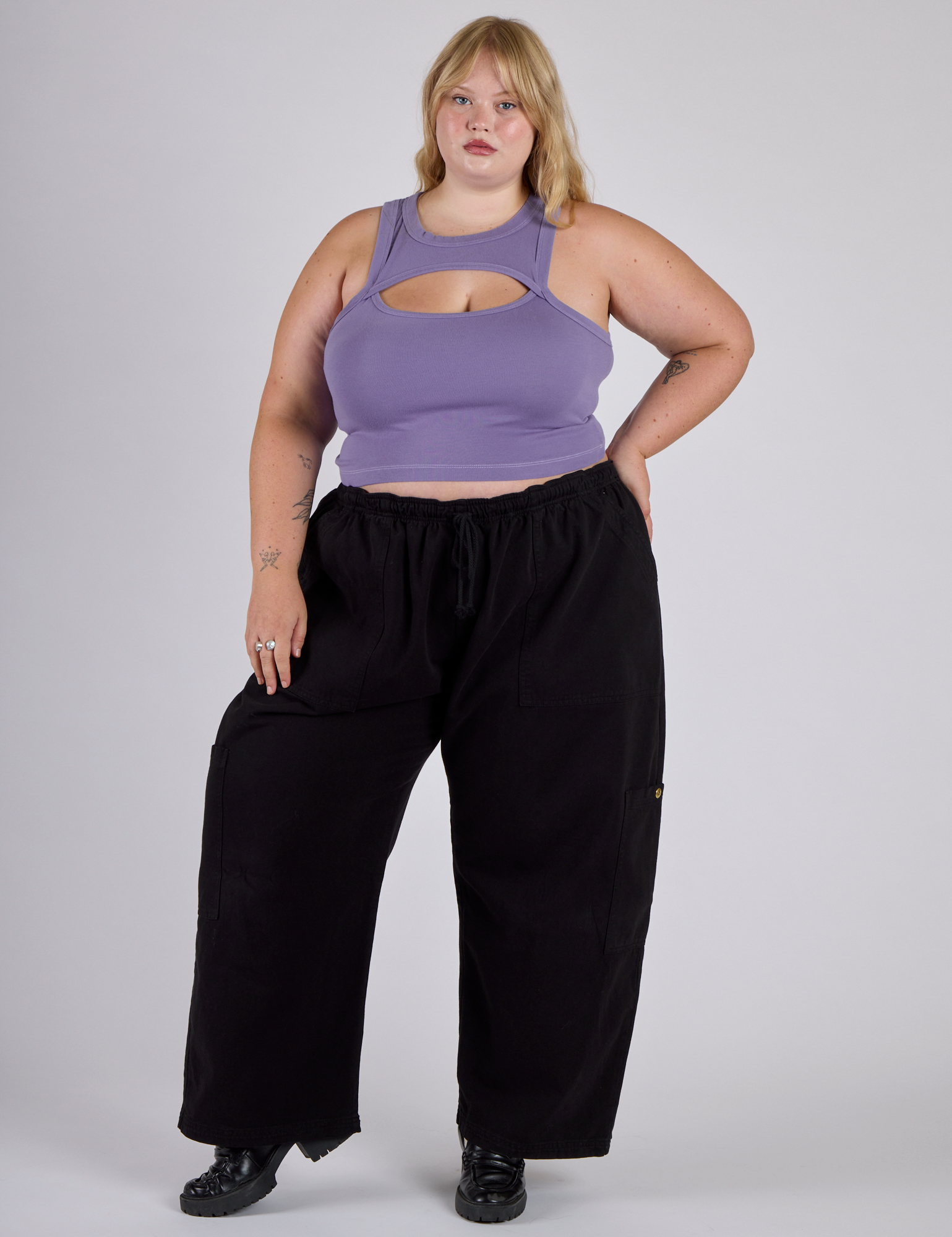 Juliet is wearing the Faded Grape Porthole Tank with Black Drop Pocket Cargo Pants