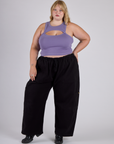 Juliet is wearing the Faded Grape Porthole Tank with Black Drop Pocket Cargo Pants