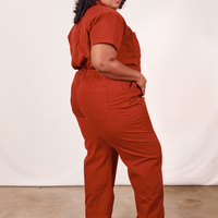 Angled side view of Short Sleeve Jumpsuit in Paprika worn by Morgan