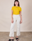 Alex is wearing JV Tee in Golden Yellow and vintage tee off-white Western Pants