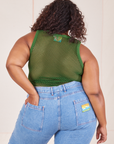 Back view of Mesh Tank Top in Lawn Green and light wash Frontier Jeans worn by Morgan