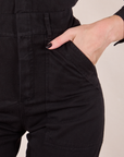 Long Sleeve Jumpsuit in Basic Black front pocket close up. Alex has her hand in the pocket