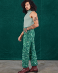 Side view of Marble Splatter Work Pants in Hunter Green and sage green Sleeveless Turtleneck on Jesse