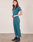 Side view of Short Sleeve Jumpsuit in Marine Blue worn by Alex