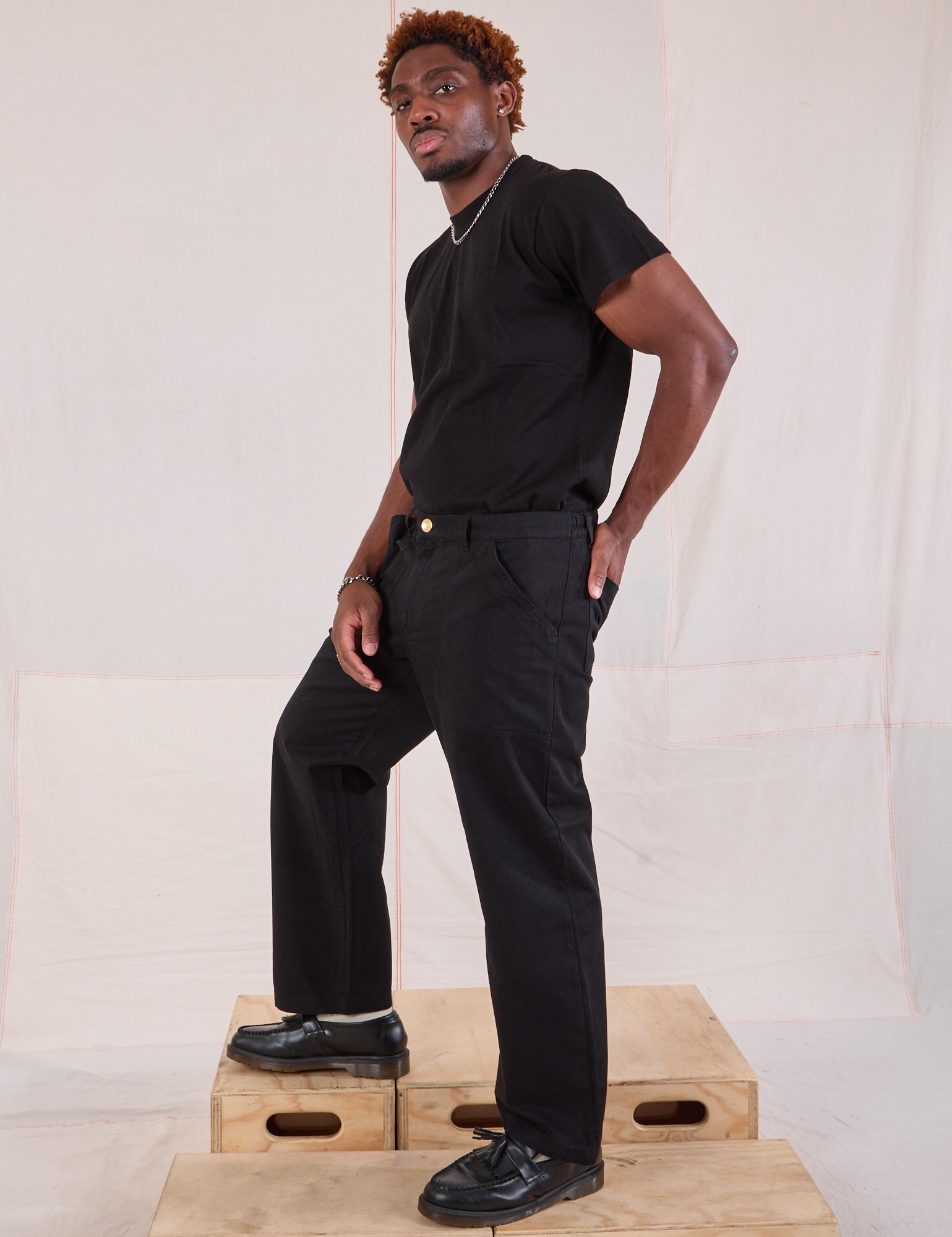 Side view of Mid-Rise Work Pants in Basic Black and black Organic Vintage Tee on Issac