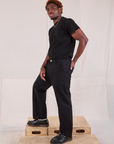 Side view of Mid-Rise Work Pants in Basic Black and black Organic Vintage Tee on Issac