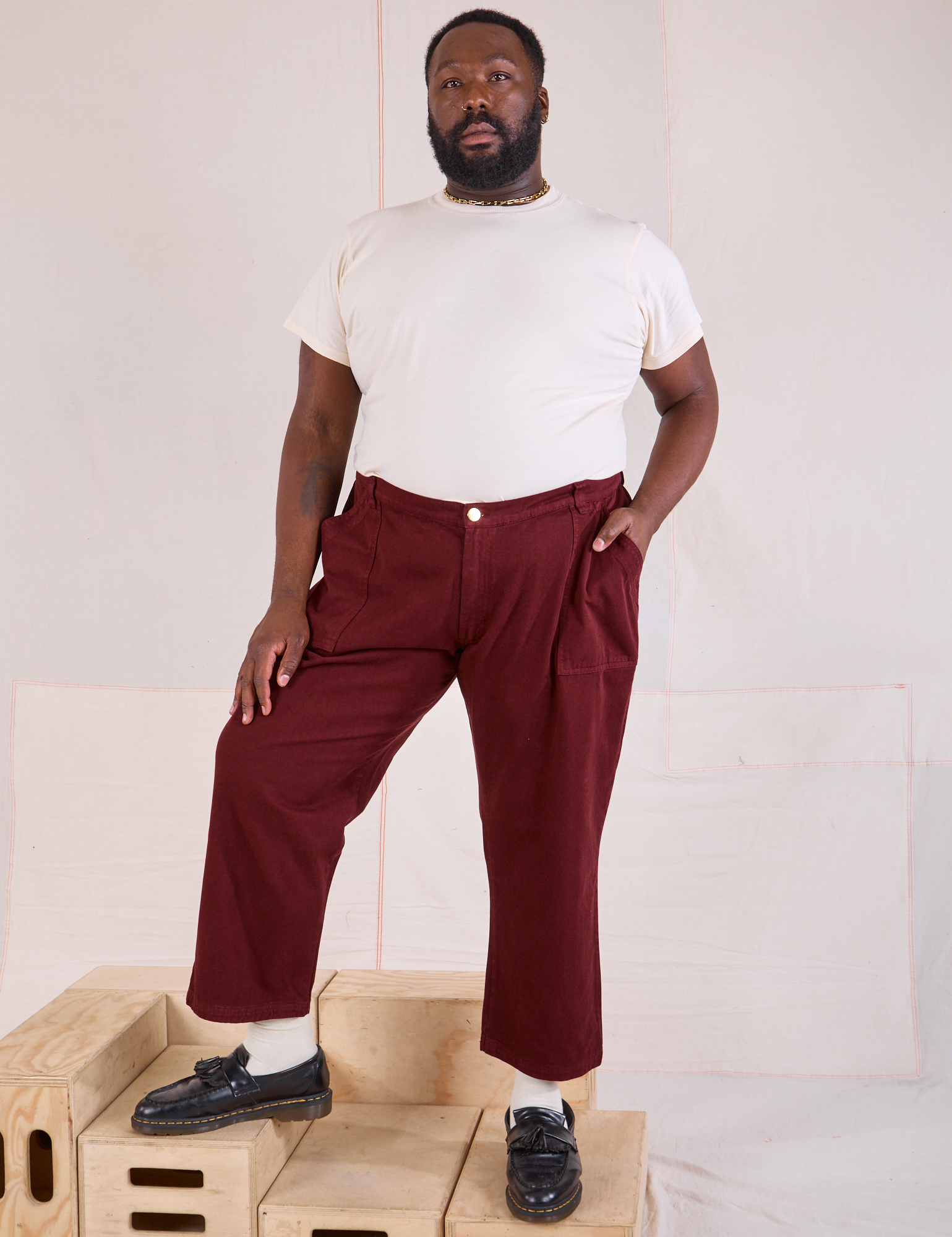 Elijah is 6&#39;3&quot; and wearing 1XL Mid-Rise Work Pants in Red Wine paired with Organic Vintage Tee in vintage tee off-white