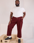 Elijah is 6'3" and wearing 1XL Mid-Rise Work Pants in Red Wine paired with Organic Vintage Tee in vintage tee off-white