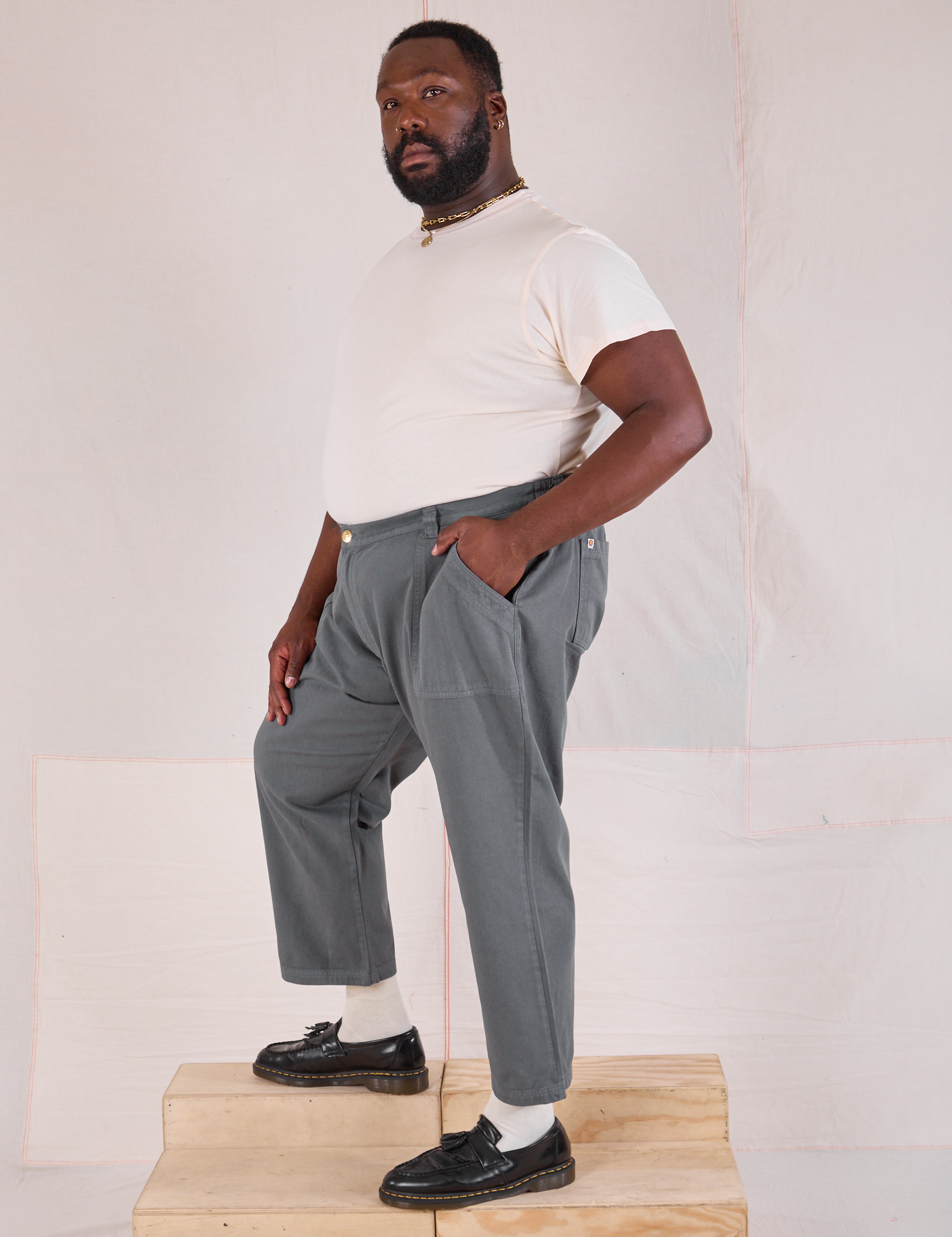 Side view of Mid-Rise Work Pants in Slate Grey and Organic Vintage Tee in vintage tee off-white on Elijah