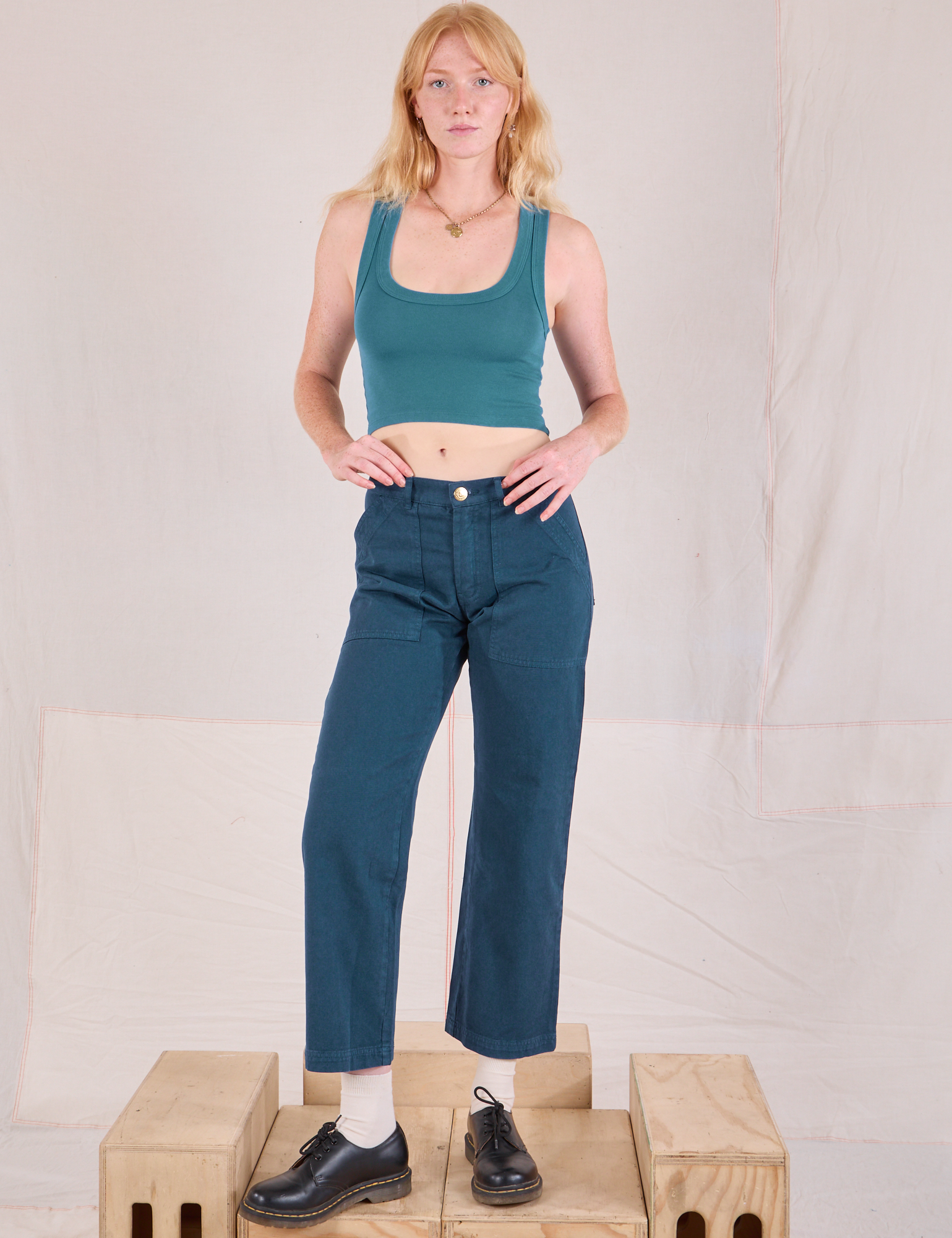 Margaret is 5&#39;11&quot; and wearing XS Mid-Rise Work Pants in Lagoon paired with marine blue Cropped Tank