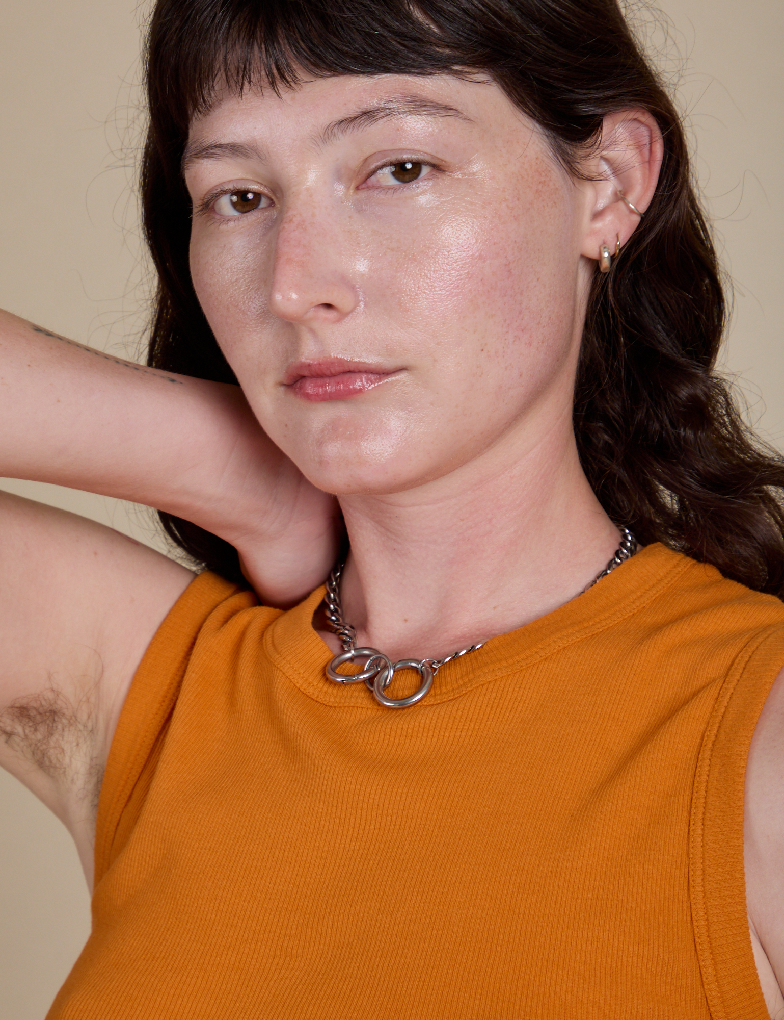 Front close up of Muscle Tee in Creamsicle Orange on Alex