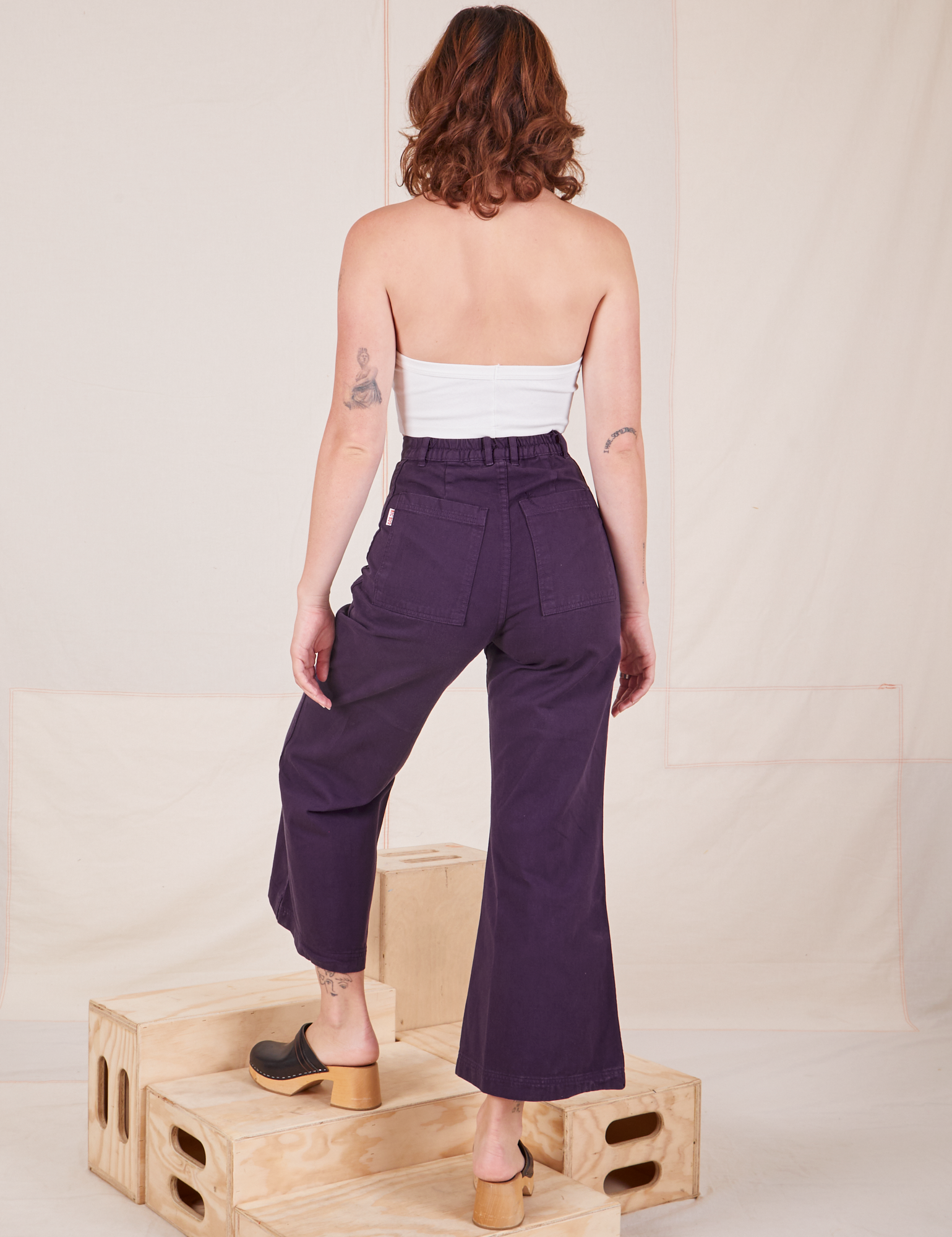 Back view of Bell Bottoms in Nebula Purple worn by Alex