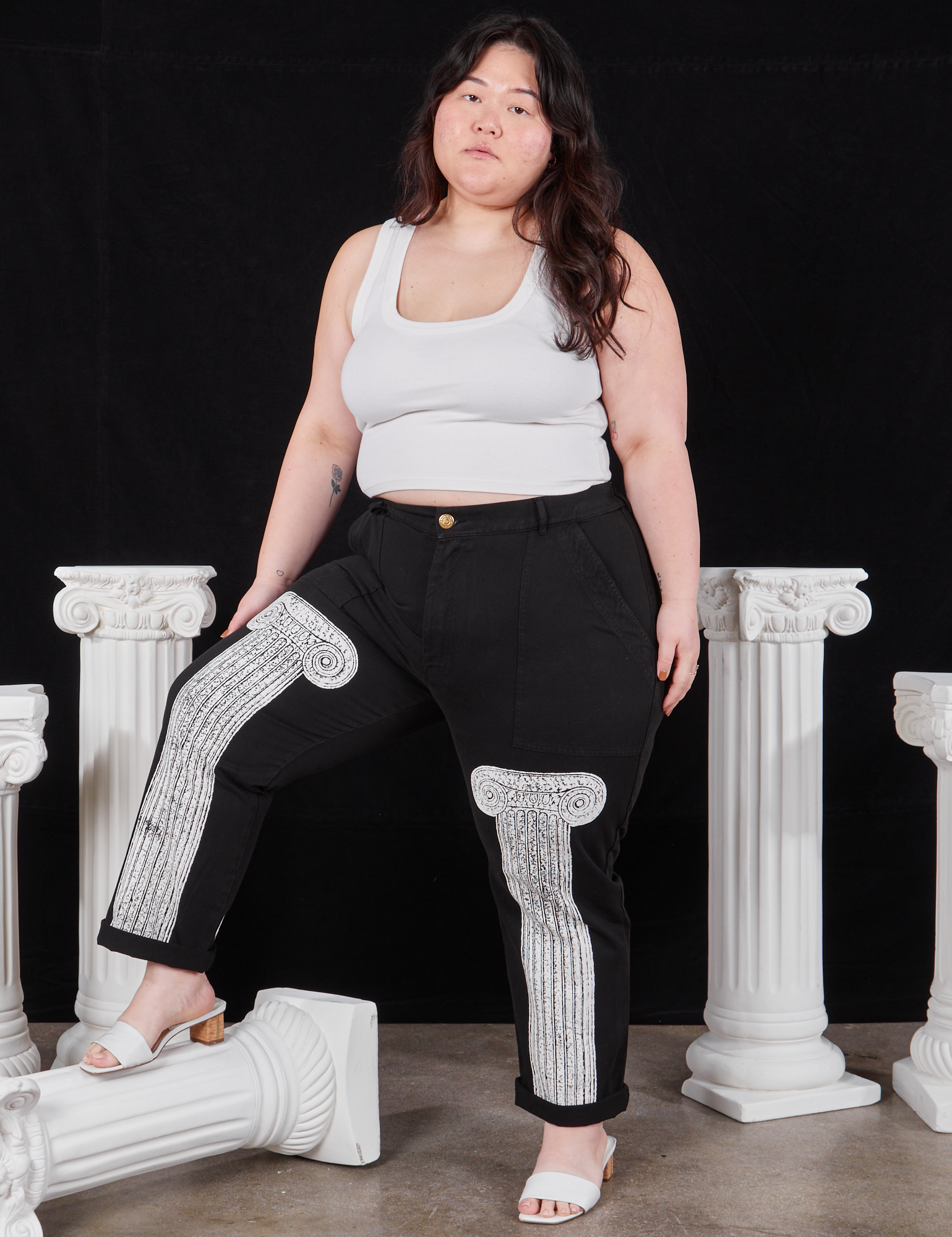 Ashley is wearing Column Work Pants in Basic Black and vintage off-white Cropped Tank Top