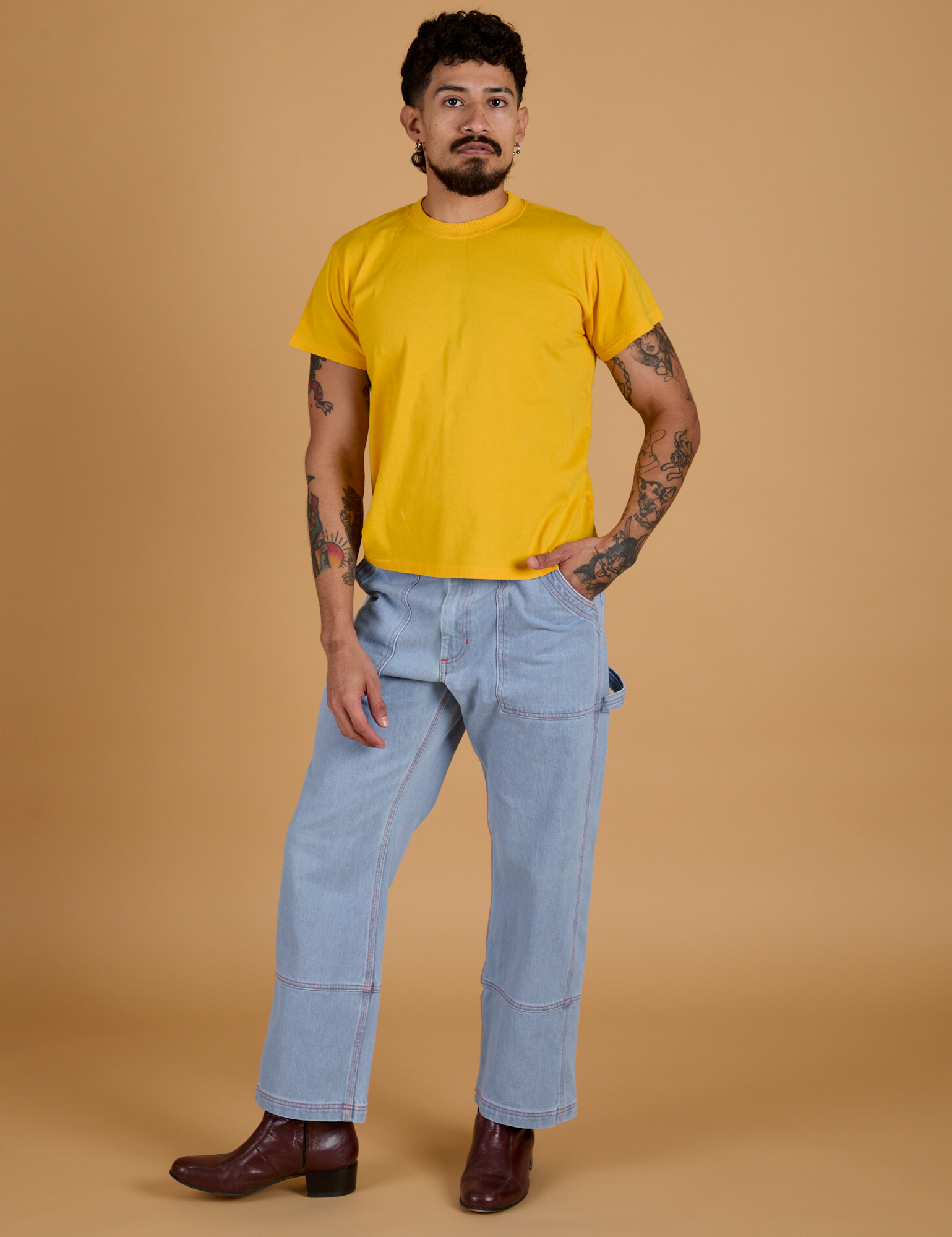 Jesse is wearing  Organic Vintage Tee in Sunshine Yellow and light wash Carpenter Jeans
