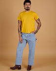 Jesse is wearing  Organic Vintage Tee in Sunshine Yellow and light wash Carpenter Jeans