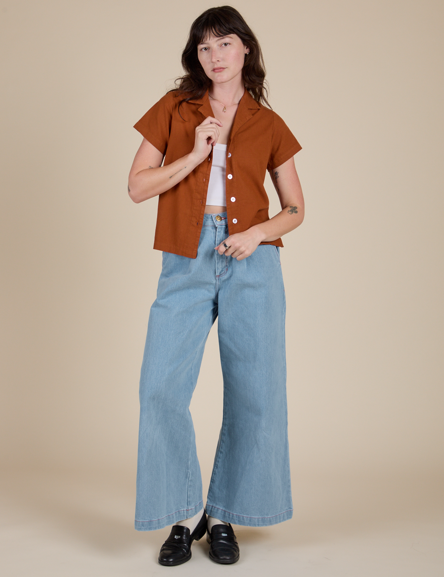 Alex is wearing Pantry Button-Up in Burnt Terracotta and light wash Indigo Wide Leg Trousers