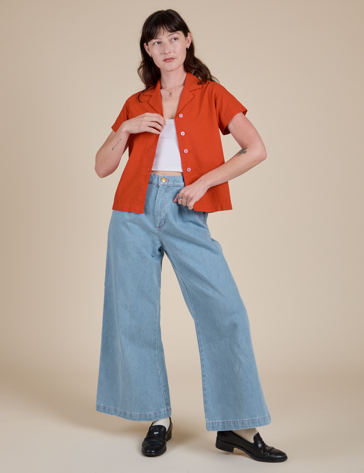 Alex is wearing Pantry Button-Up in Chili Red and light wash Indigo Wide Leg Trousers
