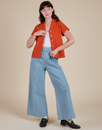 Alex is wearing Pantry Button-Up in Chili Red and light wash Indigo Wide Leg Trousers