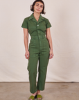Soraya is 5’2” and wearing XXS Petite Short Sleeve Jumpsuit in Dark Emerald Green