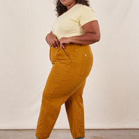 Work Pants in Spicy Mustard side view on Morgan wearing butter yellow baby Tee