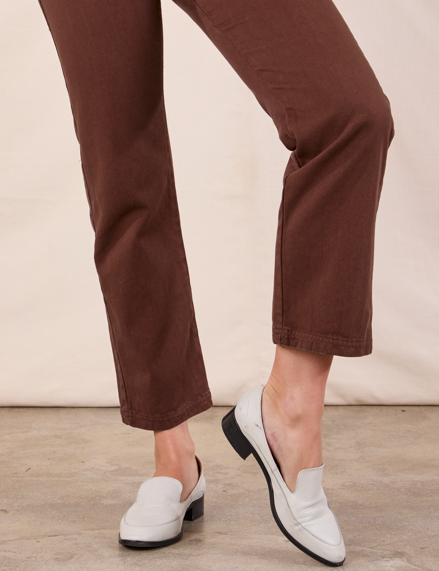 Short Sleeve Jumpsuit in Fudgesicle Brown pant leg close up on Alex