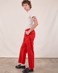 Side view of Work Pants in Mustang Red and Burly Tee in Vintage Tee Off-White