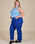 Angled front view of Racerback Tank in Baby Blue and royal blue Work Pants on Juliet