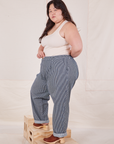 Side view of Denim Trouser Jeans in Railroad Stripe and vintage off-white Tank Top worn by Ashley