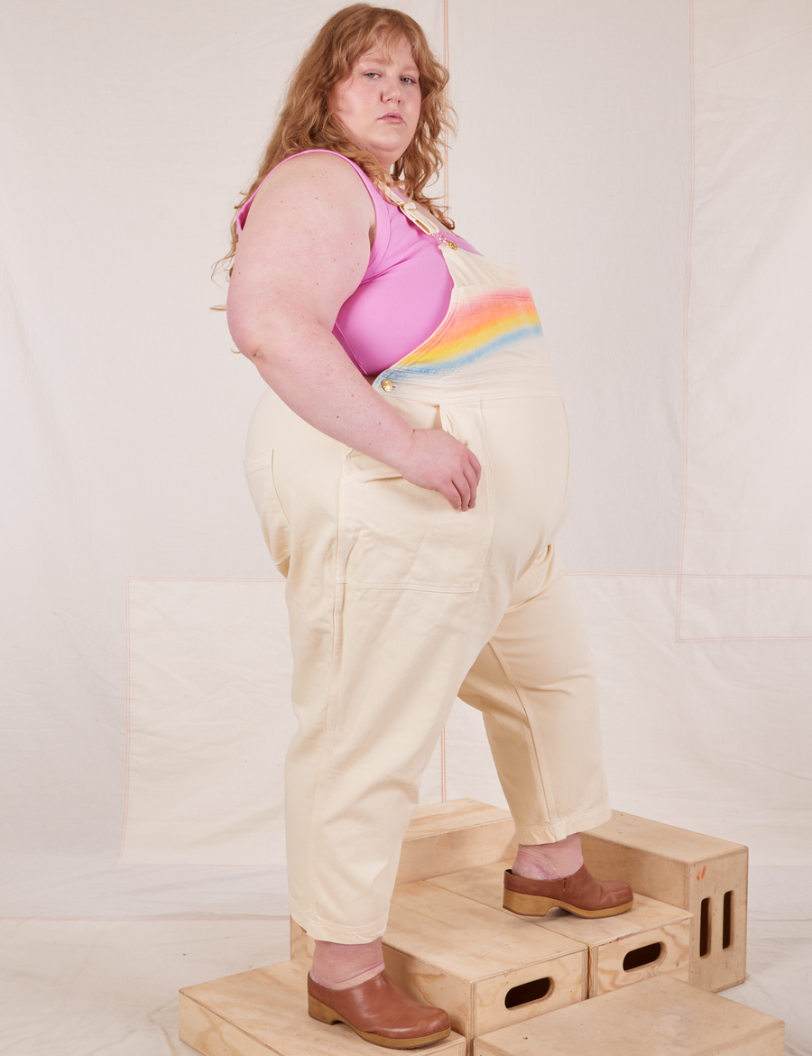 Side view of Rainbow Overalls and bubblegum pink Cropped Tank Top on Catie