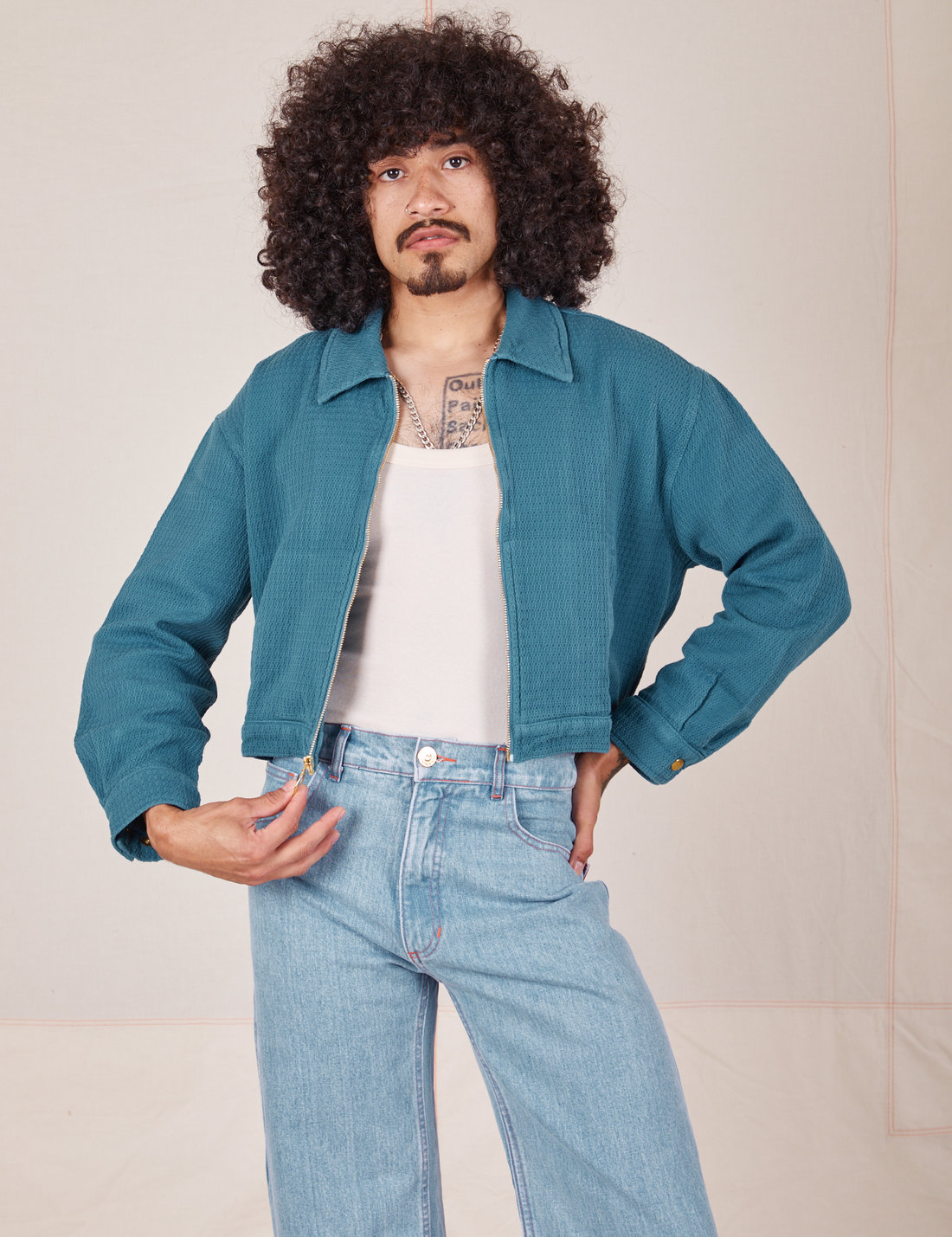 Ricky Jacket in Marine Blue, vintage off-white Tank Top, and light wash Frontier Jeans on Jesse