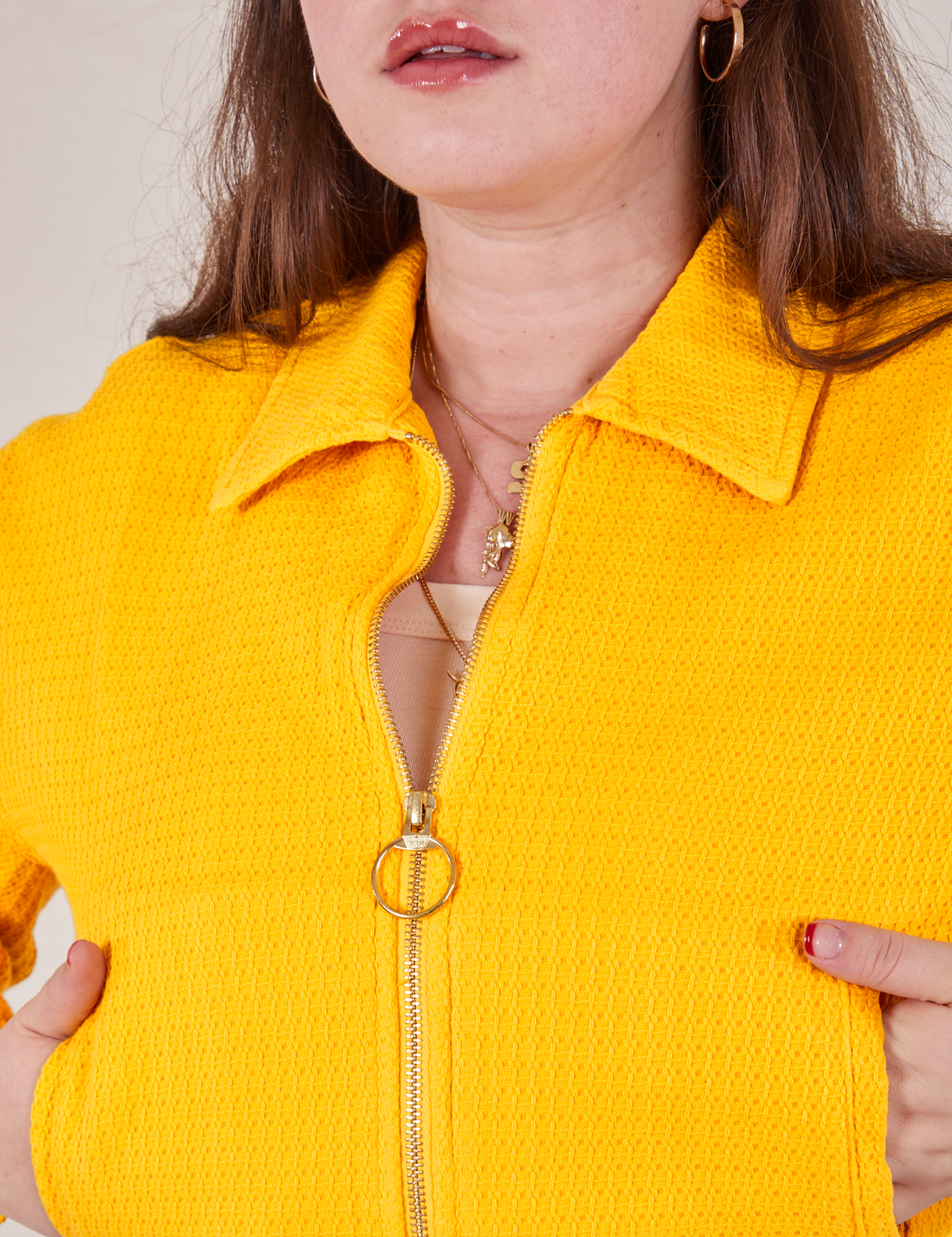Front cloes up of Ricky Jacket in Sunshine Yellow. Brass circle pull tab on zipper.