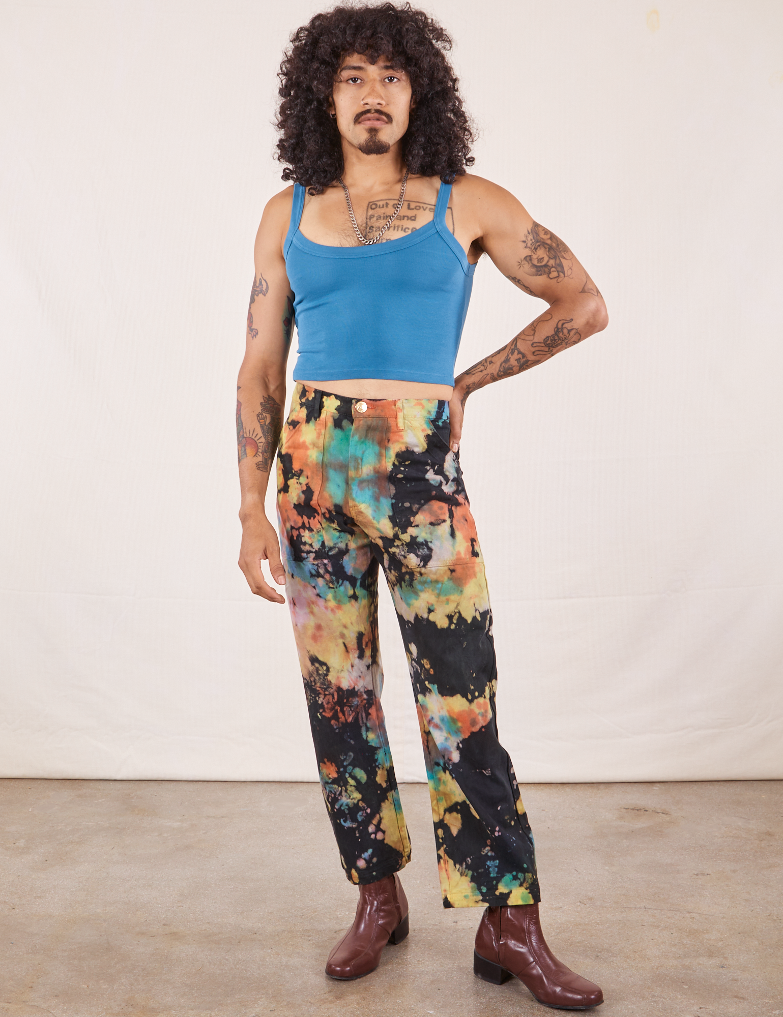 Jesse is 5&#39;8&quot; and wearing XS Rainbow Magic Waters Work Pants paired with marine blue Cropped Cami