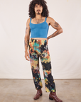 Jesse is 5'8" and wearing XS Rainbow Magic Waters Work Pants paired with marine blue Cropped Cami