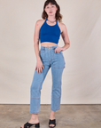 Alex is wearing Halter Top in Royal Blue and light wash Carpenter Jeans