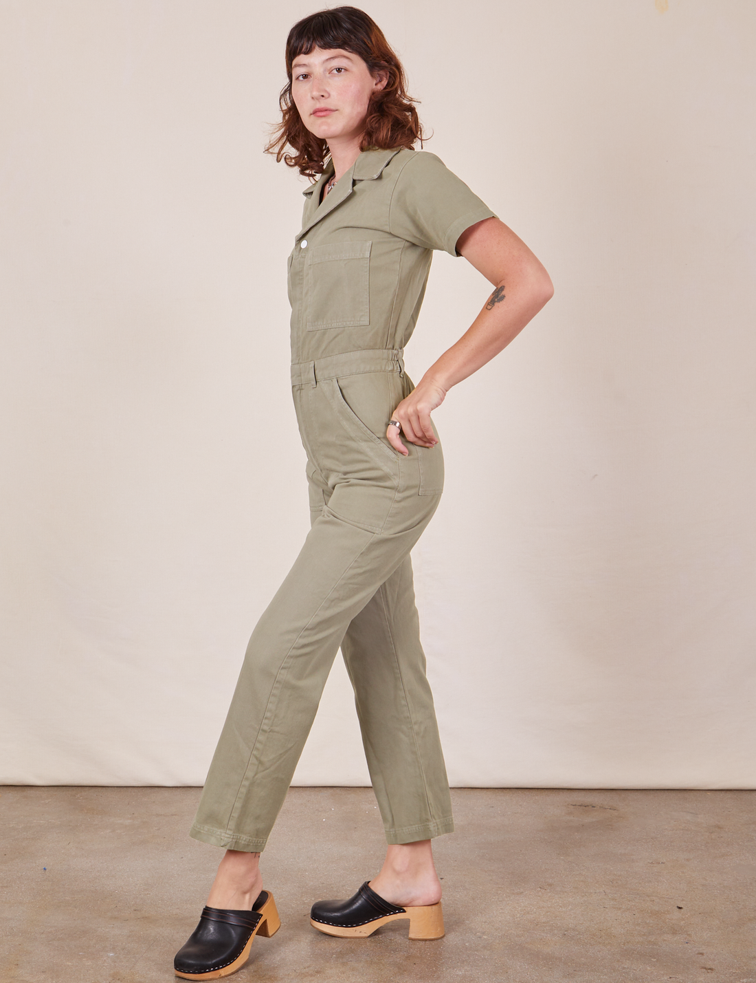 Side view of Short Sleeve Jumpsuit in Khaki Grey worn by Alex