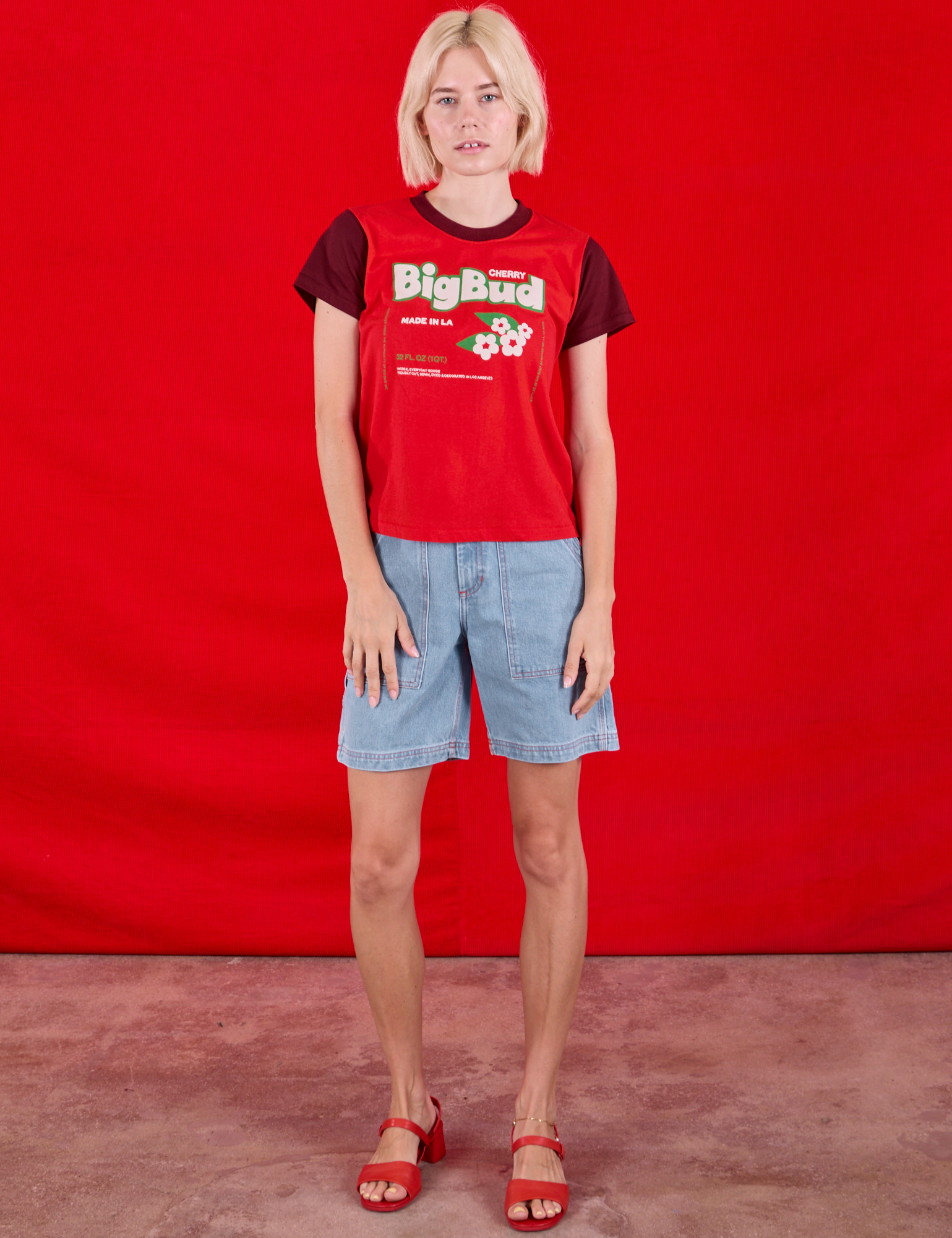 Madeline is wearing Vintage Tee in Cherry Soda and light wash Carpenter Shorts
