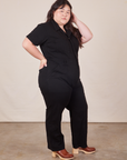 Side view of Short Sleeve Jumpsuit in Basic Black worn by Ashley