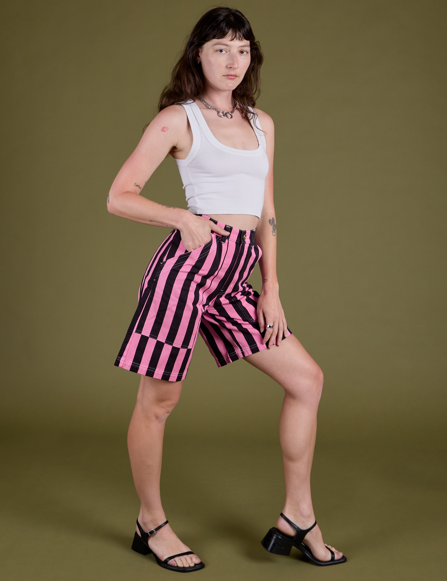 Angled front view of Longline Work Shorts in Bubblegum Pink and vintage tee white Cropped Tank on Alex